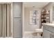 Clean bathroom featuring modern gray cabinets, a shower with a curtain, and artistic decor at 7607 Boca Raton Dr, Las Vegas, NV 89113