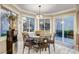 Bright dining area features a round table, pendant lighting, and sliding door access to the patio at 7607 Boca Raton Dr, Las Vegas, NV 89113