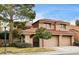 Charming two-story home featuring a tile roof, mature landscaping, and a two-car garage at 7607 Boca Raton Dr, Las Vegas, NV 89113