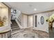 Grand foyer featuring a staircase, hardwood floors, and an elegant front door with glass detailing at 7607 Boca Raton Dr, Las Vegas, NV 89113