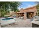 Hot tub and outdoor kitchen area with stainless steel grill, covered patio and outdoor seating at 7607 Boca Raton Dr, Las Vegas, NV 89113