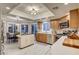 Bright kitchen with stainless steel appliances, an island, wood cabinets, and an adjacent dining area at 7607 Boca Raton Dr, Las Vegas, NV 89113