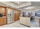 Modern kitchen featuring stainless steel appliances, a central island, wooden cabinets, and an eat-in dining area at 7607 Boca Raton Dr, Las Vegas, NV 89113