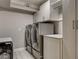 Well-equipped laundry room with modern washer and dryer units and ample storage cabinets at 7607 Boca Raton Dr, Las Vegas, NV 89113