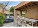 View of the outdoor bar and kitchen area with bar stool seating and brick patio at 7607 Boca Raton Dr, Las Vegas, NV 89113