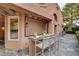 View of the outdoor bar with bar stool seating and brick patio at 7607 Boca Raton Dr, Las Vegas, NV 89113