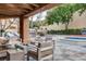 View of patio featuring fire pit seating, outdoor kitchen with grill, and built-in hot tub at 7607 Boca Raton Dr, Las Vegas, NV 89113