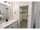 Clean bathroom vanity adjacent to a walk-in closet with vinyl flooring at 7808 Wavering Pine Dr, Las Vegas, NV 89143