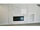 Close up of the fireplace with built-in shelving on a marble accent wall at 7808 Wavering Pine Dr, Las Vegas, NV 89143