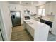 Modern kitchen with stainless steel appliances, center island, and white cabinetry at 7808 Wavering Pine Dr, Las Vegas, NV 89143