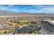 Wide aerial shot of the community, displaying the community center, golf course, tennis courts, and surrounding houses at 7828 Homing Pigeon St, North Las Vegas, NV 89084