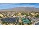 Scenic aerial view of the community with the community center, tennis courts, golf course, and homes at 7828 Homing Pigeon St, North Las Vegas, NV 89084