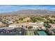 Beautiful aerial view of the community center, golf course, houses, and mountain range in the distance at 7828 Homing Pigeon St, North Las Vegas, NV 89084