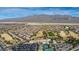 Expansive aerial view of the community featuring a golf course, community center, tennis courts, and houses at 7828 Homing Pigeon St, North Las Vegas, NV 89084