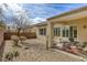 Cozy backyard patio with a seating area, perfect for outdoor relaxation and entertaining in a low maintenance yard at 7828 Homing Pigeon St, North Las Vegas, NV 89084