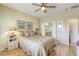 Comfortable bedroom featuring a ceiling fan, and a doorway to a private ensuite bathroom at 7828 Homing Pigeon St, North Las Vegas, NV 89084