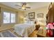 Charming bedroom with a ceiling fan, and bright, natural lighting through the large windows at 7828 Homing Pigeon St, North Las Vegas, NV 89084