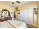 Inviting bedroom with a ceiling fan, ensuite bathroom, and large closet with sliding doors at 7828 Homing Pigeon St, North Las Vegas, NV 89084