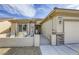 Charming front exterior featuring a private patio, a two-car garage, and desert-friendly landscaping at 7828 Homing Pigeon St, North Las Vegas, NV 89084