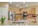 Kitchen featuring granite countertops, stainless steel appliances, and ample cabinet space at 7828 Homing Pigeon St, North Las Vegas, NV 89084