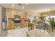 Kitchen featuring granite counters and backsplash and stainless steel appliances at 7828 Homing Pigeon St, North Las Vegas, NV 89084