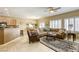 Open living space featuring tile floors, comfortable seating, and seamless flow to the dining area at 7828 Homing Pigeon St, North Las Vegas, NV 89084