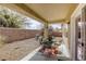 Covered patio with a seating area and a view of the gravel landscaped backyard at 7828 Homing Pigeon St, North Las Vegas, NV 89084