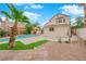 The backyard features a pool, mature landscaping and a large shade tree at 8324 Shark Tank Ct, Las Vegas, NV 89128