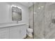 Bathroom featuring modern vanity and shower with marble-look tile and glass doors at 8324 Shark Tank Ct, Las Vegas, NV 89128