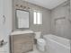 Updated bathroom featuring modern vanity, tub and shower with gray tiling at 8324 Shark Tank Ct, Las Vegas, NV 89128