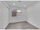 This bedroom has gray wood floors, neutral paint and a window looking out to the backyard at 8324 Shark Tank Ct, Las Vegas, NV 89128