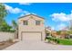 Two-story home featuring a two car garage, desert landscaping, and well-maintained front lawn at 8324 Shark Tank Ct, Las Vegas, NV 89128