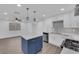 Modern kitchen with white cabinets, stainless steel appliances, and blue island at 8324 Shark Tank Ct, Las Vegas, NV 89128