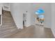 Living room with stairs, white walls, wood floors, and sliding glass doors to outdoor pool at 8324 Shark Tank Ct, Las Vegas, NV 89128