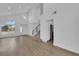 Large living room featuring modern staircase, front door, and view into adjacent kitchen at 8324 Shark Tank Ct, Las Vegas, NV 89128