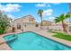 A gorgeous backyard pool with a spa, lovely landscaping, and stucco home exterior at 8324 Shark Tank Ct, Las Vegas, NV 89128