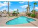 Sparkling pool with mature landscaping and shade structure create an outdoor oasis at 8324 Shark Tank Ct, Las Vegas, NV 89128