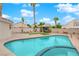 A beautiful backyard pool with a spa, nice hardscape, and lush landscaping at 8324 Shark Tank Ct, Las Vegas, NV 89128