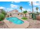 Inviting backyard pool, with a spa, a quaint cabana, and mature palm trees at 8324 Shark Tank Ct, Las Vegas, NV 89128