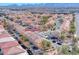 An aerial perspective of a vibrant residential area with well-maintained houses, solar panels, and lush greenery at 840 Sheerwater Ave, Henderson, NV 89052