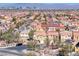 Neighborhood aerial view with similar-style homes, landscaped yards, and the city skyline in the distant background at 840 Sheerwater Ave, Henderson, NV 89052