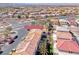 An aerial shot showcases the neighborhood with well-kept yards, palm trees, and a view of the surrounding landscape at 840 Sheerwater Ave, Henderson, NV 89052