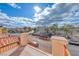 Balcony view shows the homes across the street, neat landscaping, and blue skies with scattered clouds at 840 Sheerwater Ave, Henderson, NV 89052