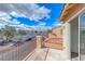 Balcony view shows neighborhood street with neat landscaping, and blue skies with scattered clouds at 840 Sheerwater Ave, Henderson, NV 89052