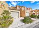 A front exterior view showing a two-story townhome with a two-car garage and landscaped front yard at 840 Sheerwater Ave, Henderson, NV 89052