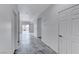 Hallway with neutral tones and grey-marbled tile, connecting various rooms and showcasing the home's layout at 840 Sheerwater Ave, Henderson, NV 89052