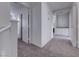 Upstairs hallway features neutral carpet, white trim, and an arched ceiling detail at 840 Sheerwater Ave, Henderson, NV 89052