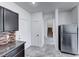 Kitchen with stainless steel appliances, granite countertops, and tile flooring extending to the staircase at 840 Sheerwater Ave, Henderson, NV 89052