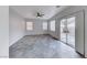 Spacious living room with expansive grey-marbled floors, a modern ceiling fan, and abundant natural light at 840 Sheerwater Ave, Henderson, NV 89052