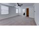 Spacious main bedroom with ceiling fan, neutral carpet, and ensuite bath with walk-in closet at 840 Sheerwater Ave, Henderson, NV 89052